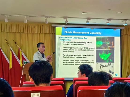 A person standing in front of a screen

Description automatically generated